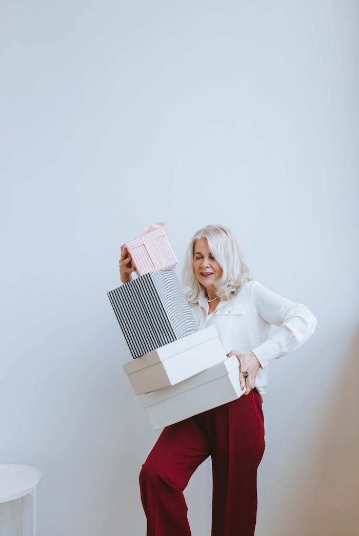 Woman in White Long Sleeve Shirt Holding White Paper